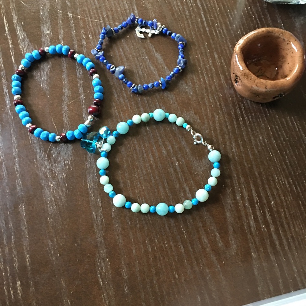 Gemstone and wood bracelets in hues of blue.